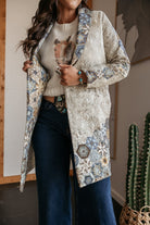 Woman in quilted western boho jacket, horse graphic sweater, and wide-leg jeans