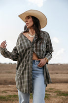 Woman in a straw cowboy hat, plaid western shirt, and distressed jeans outdoors