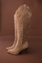 Thunderbird pendant chain necklace displayed on wooden slab with serape fabric underneath - The Wild J