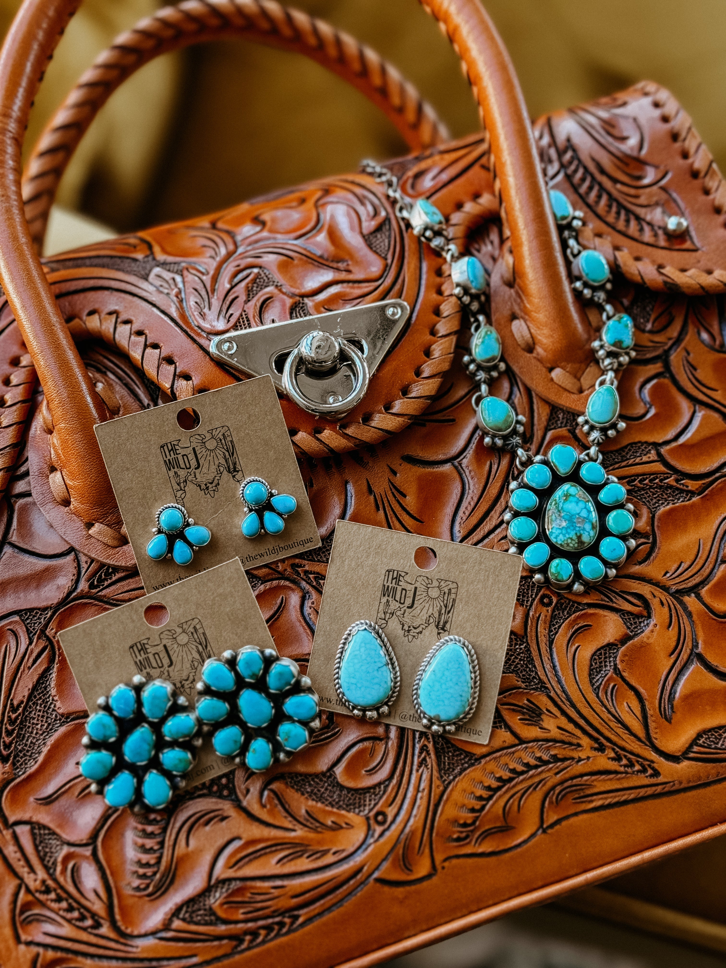 Tooled leather western handbag with turquoise boho earrings and statement necklace