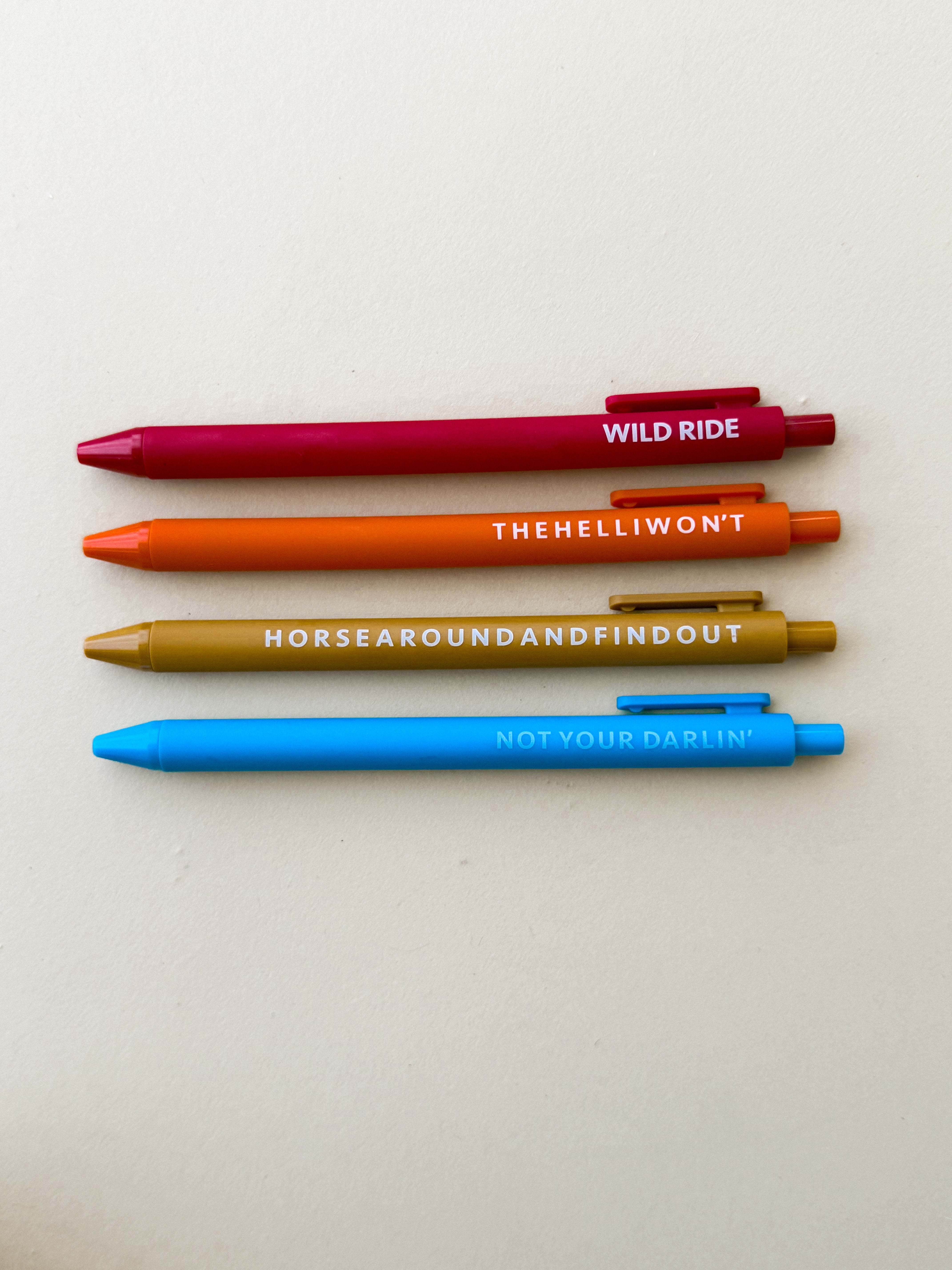 Thunderbird pendant chain necklace displayed on wooden slab with serape fabric underneath - The Wild J