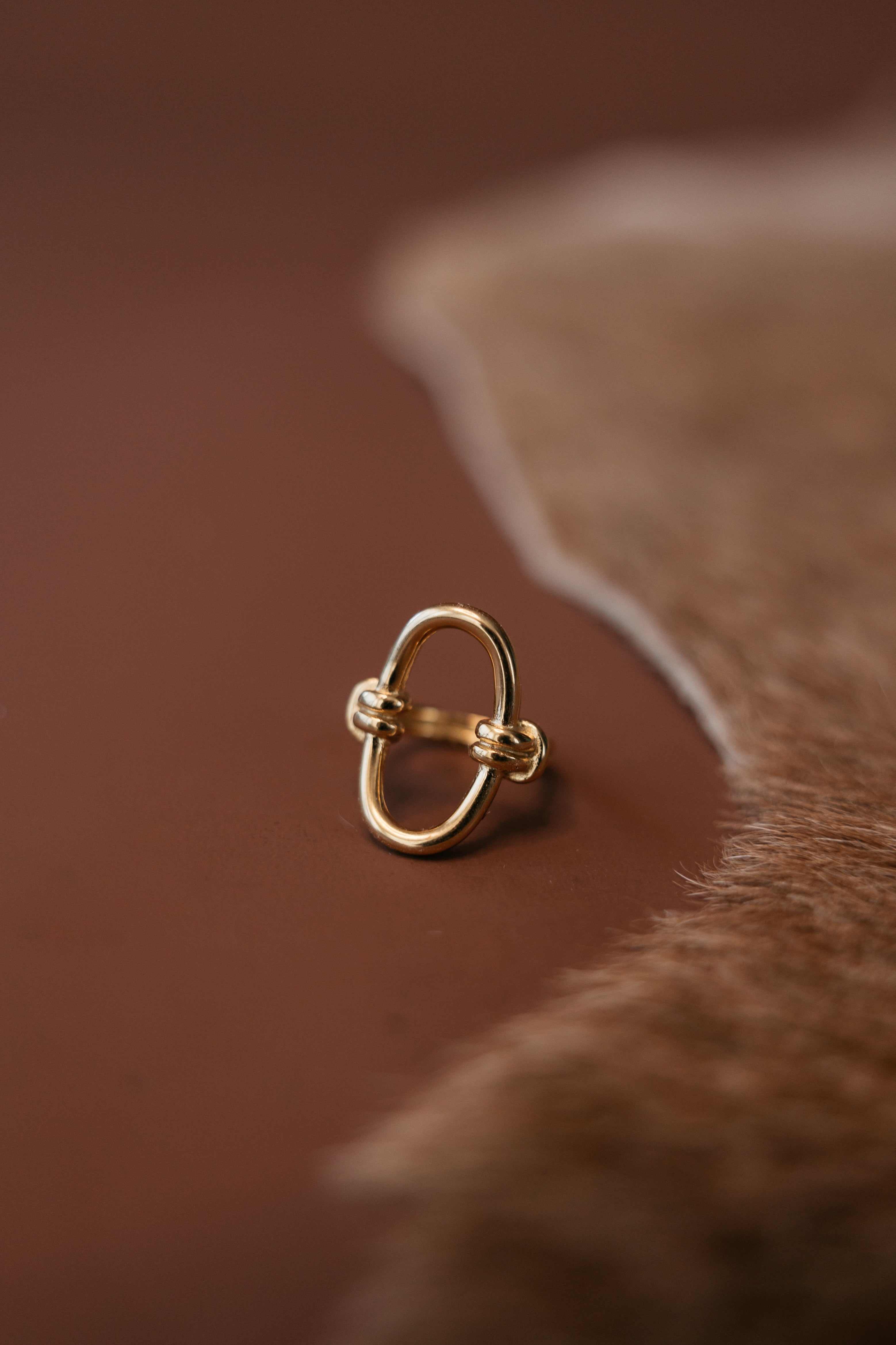 Thunderbird pendant chain necklace displayed on wooden slab with serape fabric underneath - The Wild J