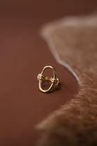 Thunderbird pendant chain necklace displayed on wooden slab with serape fabric underneath - The Wild J