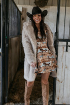 Thunderbird pendant chain necklace displayed on wooden slab with serape fabric underneath - The Wild J