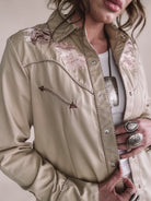 Western boho embroidered shirt with floral and horse design, silver rings, and bolo necklace