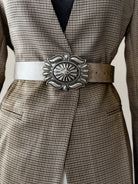 Thunderbird pendant chain necklace displayed on wooden slab with serape fabric underneath - The Wild J