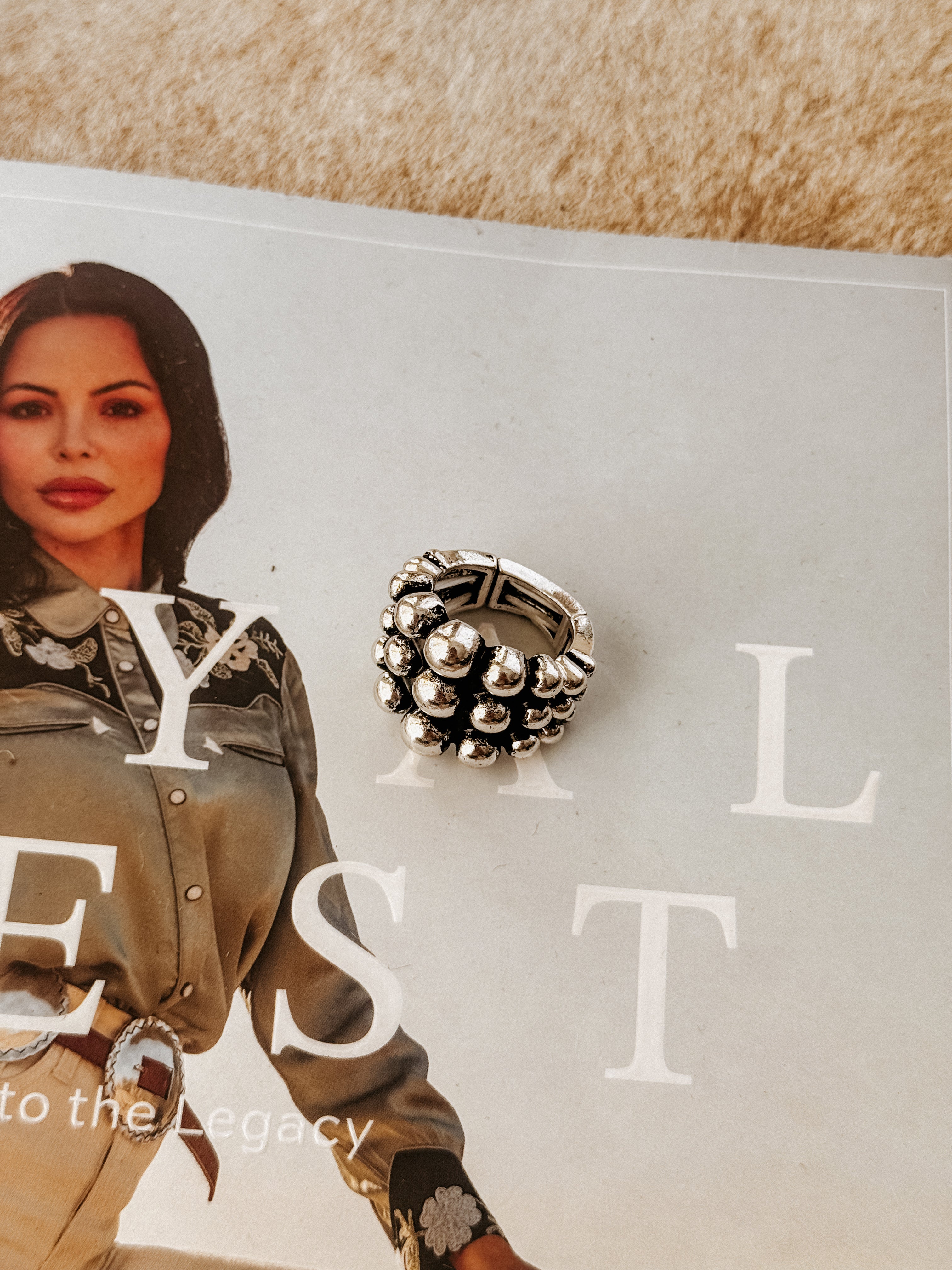 Thunderbird pendant chain necklace displayed on wooden slab with serape fabric underneath - The Wild J