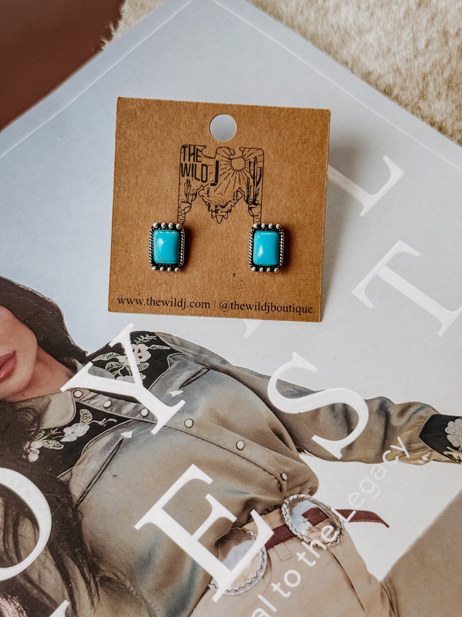 Rectangle-shaped stud earrings featuring a vibrant turquoise center stone, surrounded by a burnished silver beaded frame. Lightweight with post-back closure