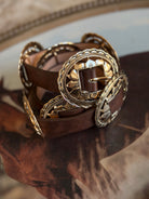 Brown western concho belt with ornate silver buckles, boho cowgirl accessory