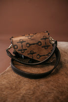 Thunderbird pendant chain necklace displayed on wooden slab with serape fabric underneath - The Wild J