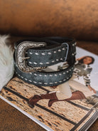 Western leather belt with silver engraved buckle and white stitching, cowgirl fashion accessory