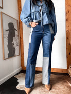 Woman wearing western patchwork denim jeans and a ruffled denim blouse, cowgirl style decor