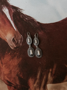 Thunderbird pendant chain necklace displayed on wooden slab with serape fabric underneath - The Wild J