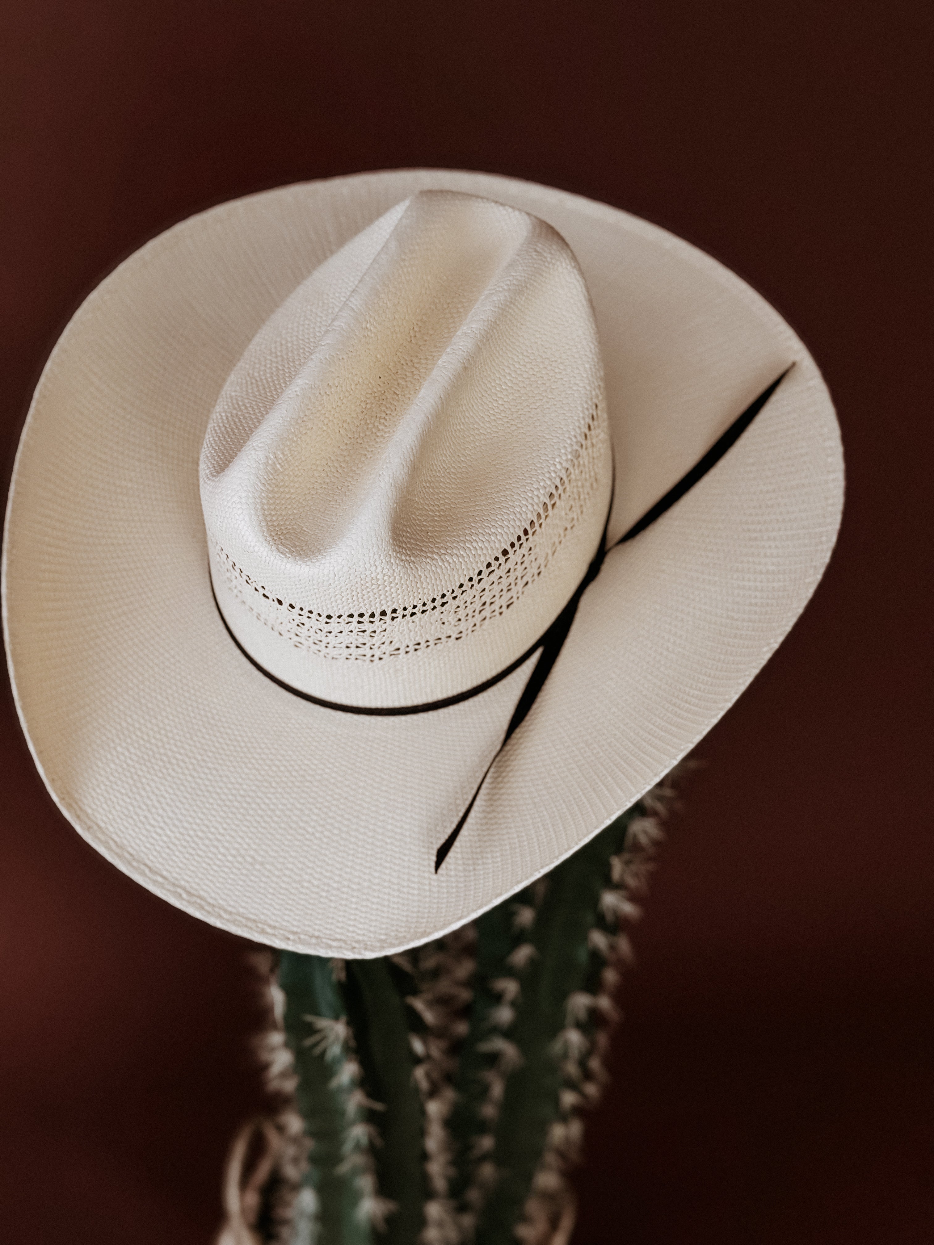 Thunderbird pendant chain necklace displayed on wooden slab with serape fabric underneath - The Wild J