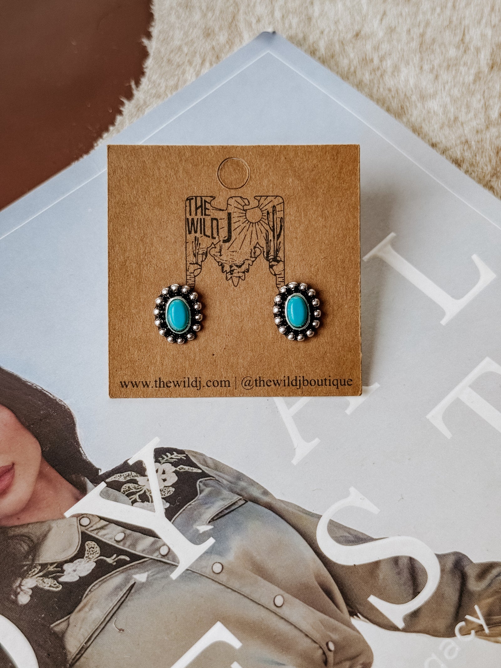 Burnished silver concho stud earrings with an oval turquoise center stone and stud backing