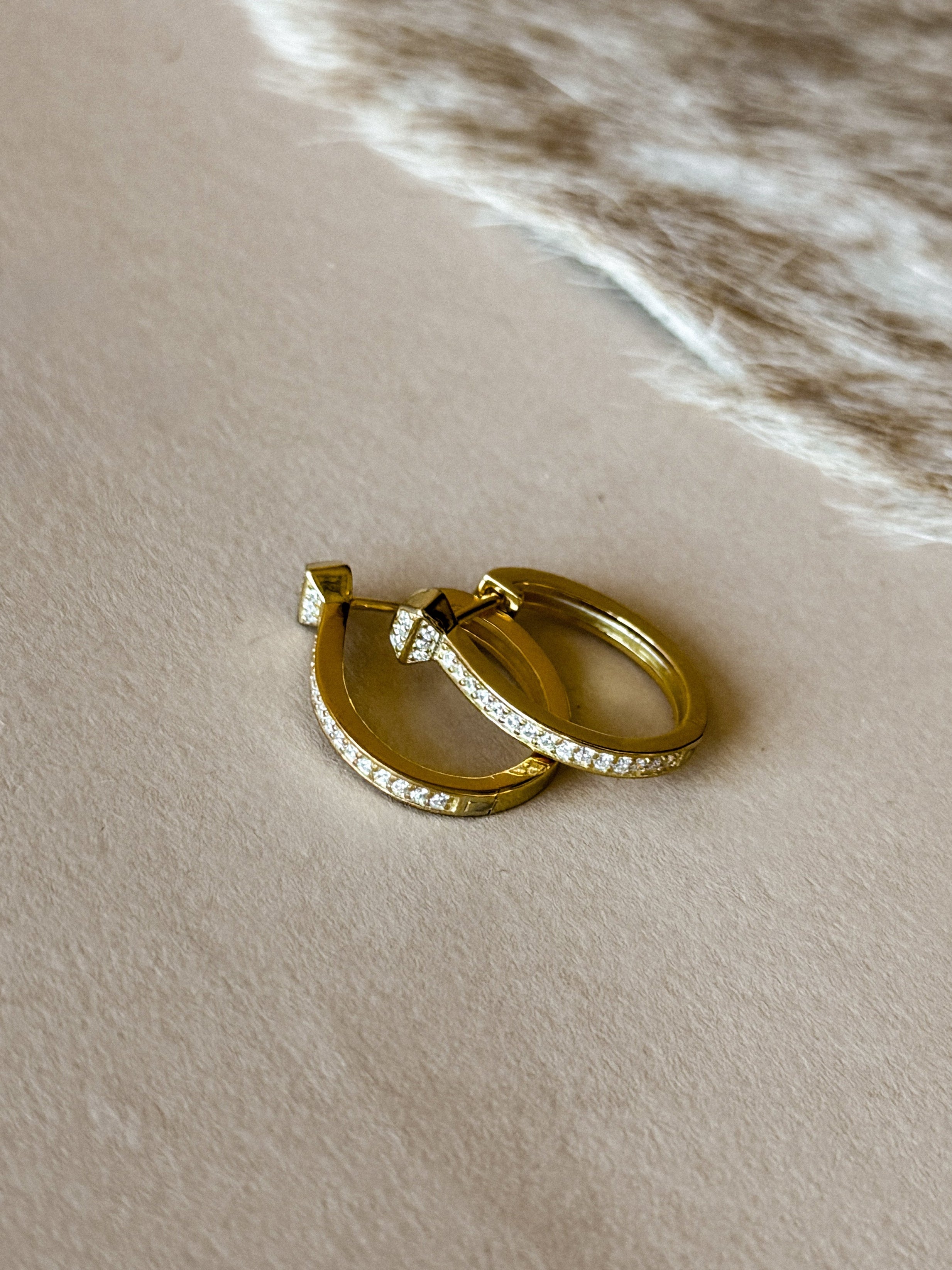 Gold‑plated sterling silver hinged hoop earrings with cubic zirconia accents.