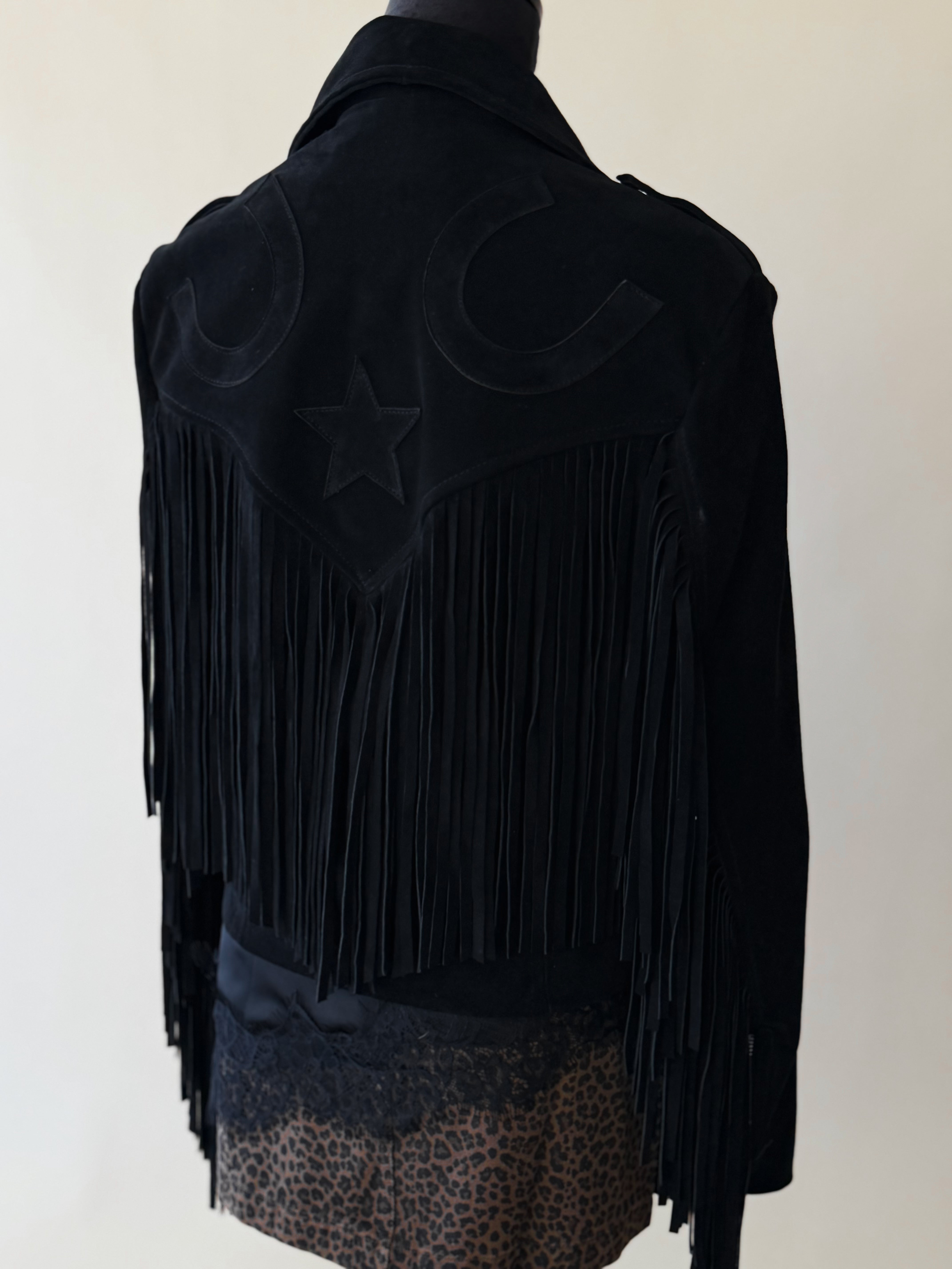 Black western fringe jacket with star and horseshoe details, styled with leopard print skirt