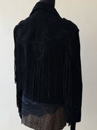 Black western fringe jacket with star and horseshoe details, styled with leopard print skirt