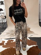 Thunderbird pendant chain necklace displayed on wooden slab with serape fabric underneath - The Wild J