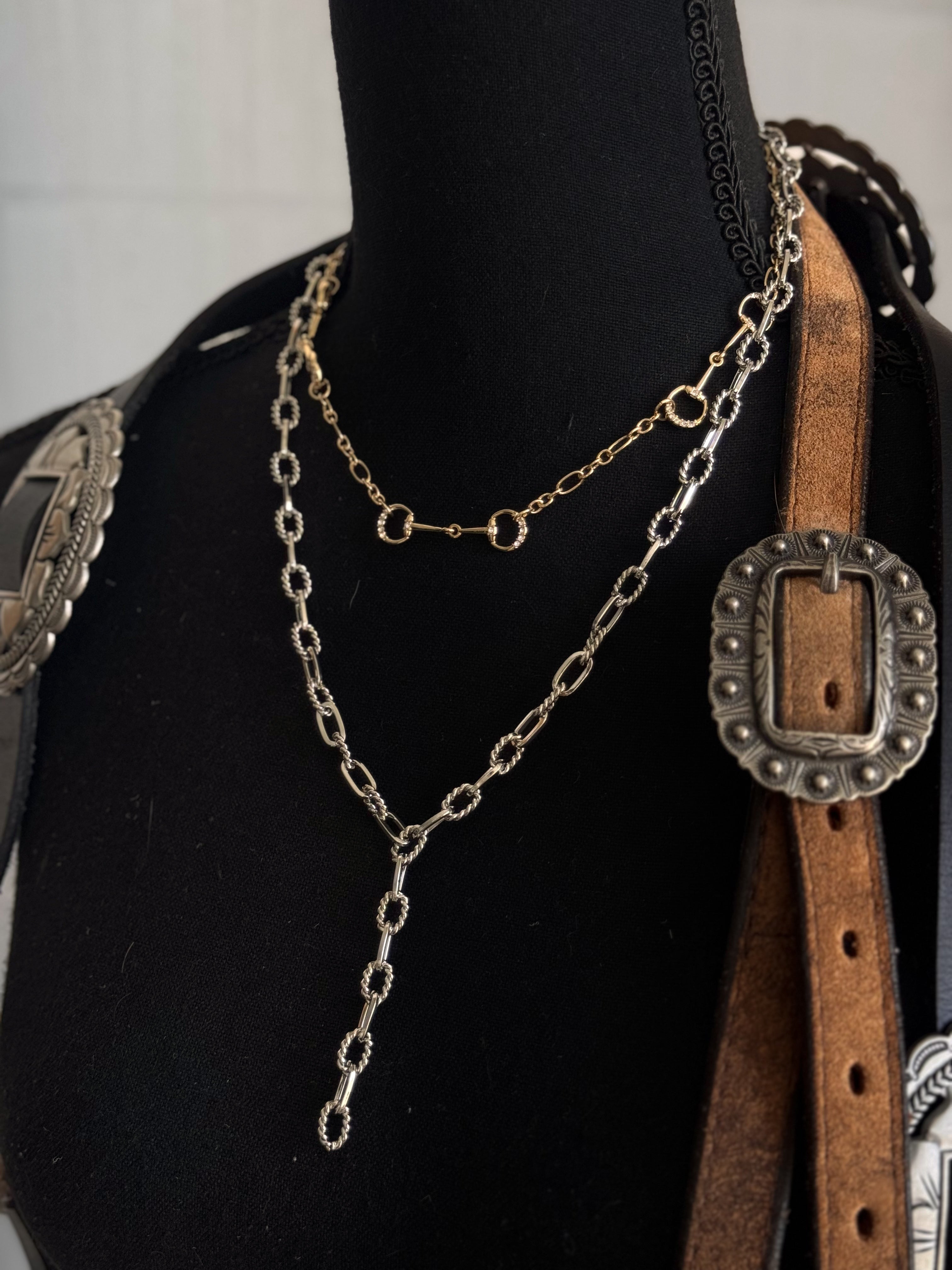 Thunderbird pendant chain necklace displayed on wooden slab with serape fabric underneath - The Wild J