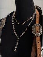 Thunderbird pendant chain necklace displayed on wooden slab with serape fabric underneath - The Wild J