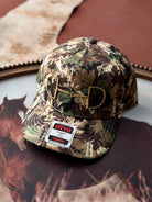 Camouflage cap with brand label on a textured surface