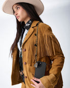 Thunderbird pendant chain necklace displayed on wooden slab with serape fabric underneath - The Wild J