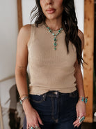 Thunderbird pendant chain necklace displayed on wooden slab with serape fabric underneath - The Wild J