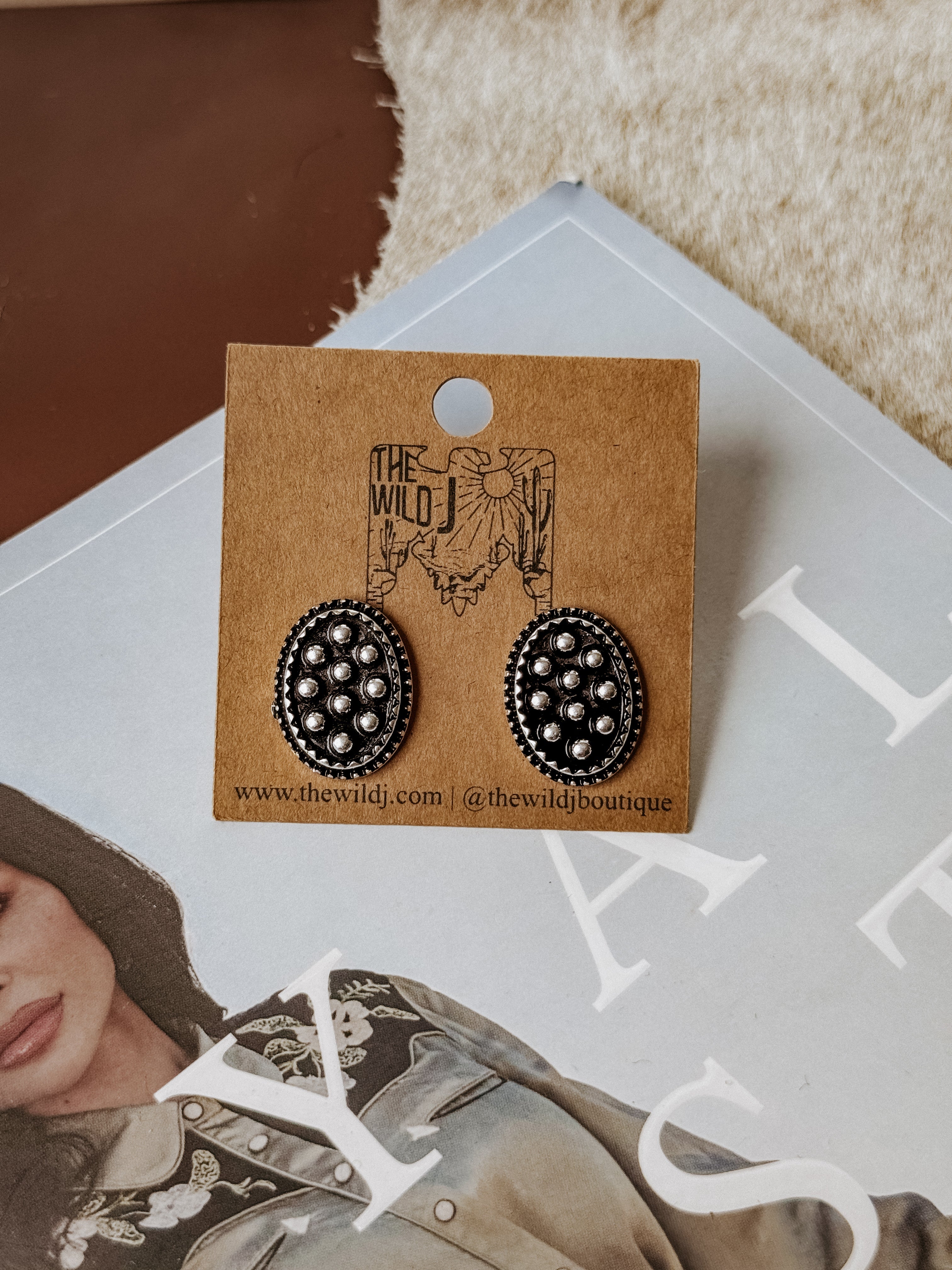 Burnished silver oval stud earrings with raised bubble detailing, lightweight design, and post-back closure