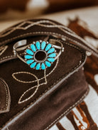 Western boho turquoise statement bracelet on embroidered brown suede bag