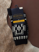 Thunderbird pendant chain necklace displayed on wooden slab with serape fabric underneath - The Wild J