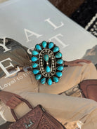 Western boho oval statement ring with turquoise stones on magazine background