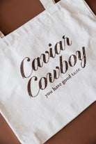 Thunderbird pendant chain necklace displayed on wooden slab with serape fabric underneath - The Wild J