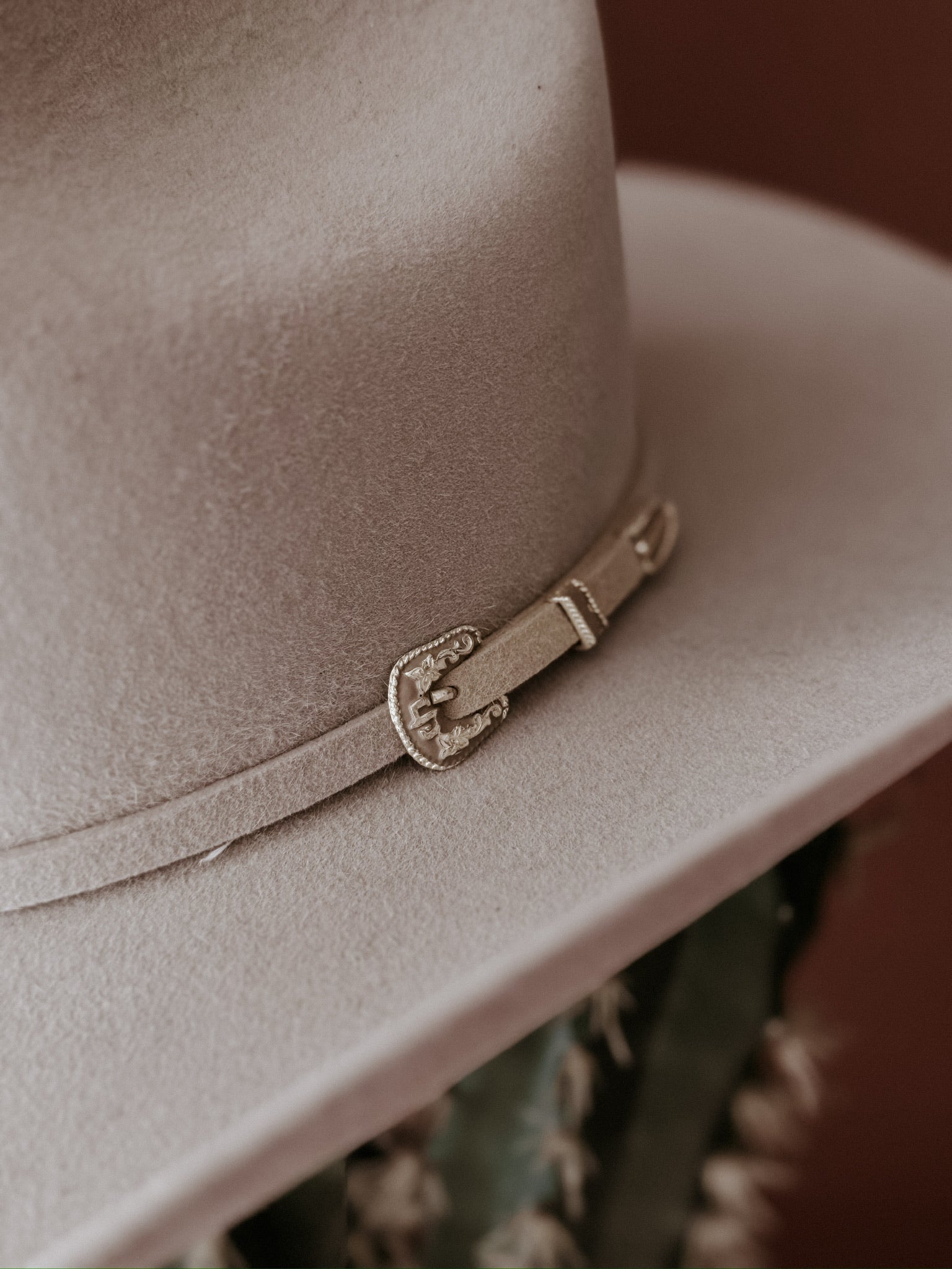 Beige felt western hat with decorative belt buckle detail, boho cowgirl accessory