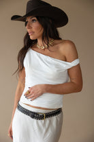 Thunderbird pendant chain necklace displayed on wooden slab with serape fabric underneath - The Wild J