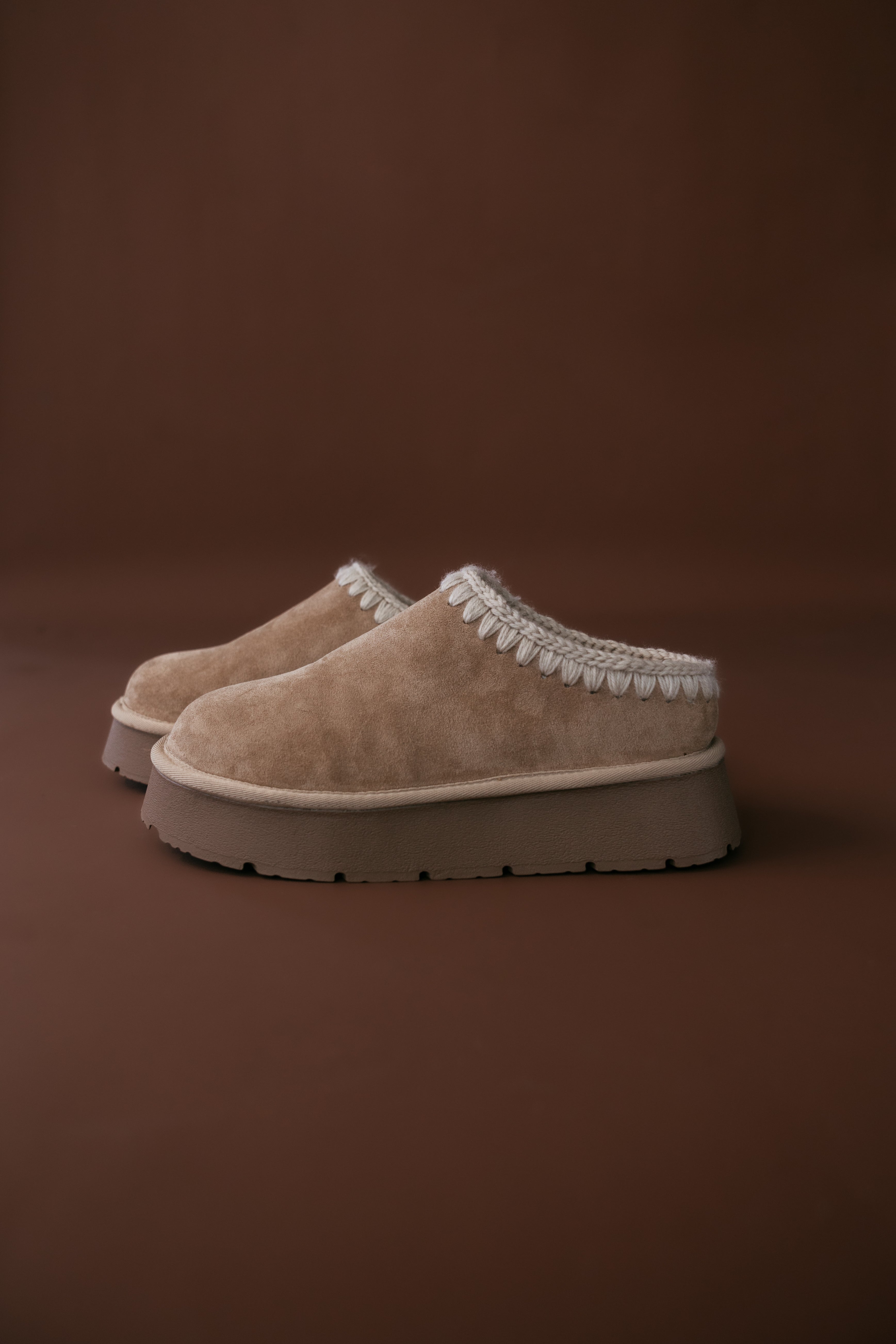 Thunderbird pendant chain necklace displayed on wooden slab with serape fabric underneath - The Wild J