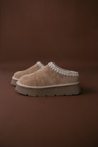 Thunderbird pendant chain necklace displayed on wooden slab with serape fabric underneath - The Wild J