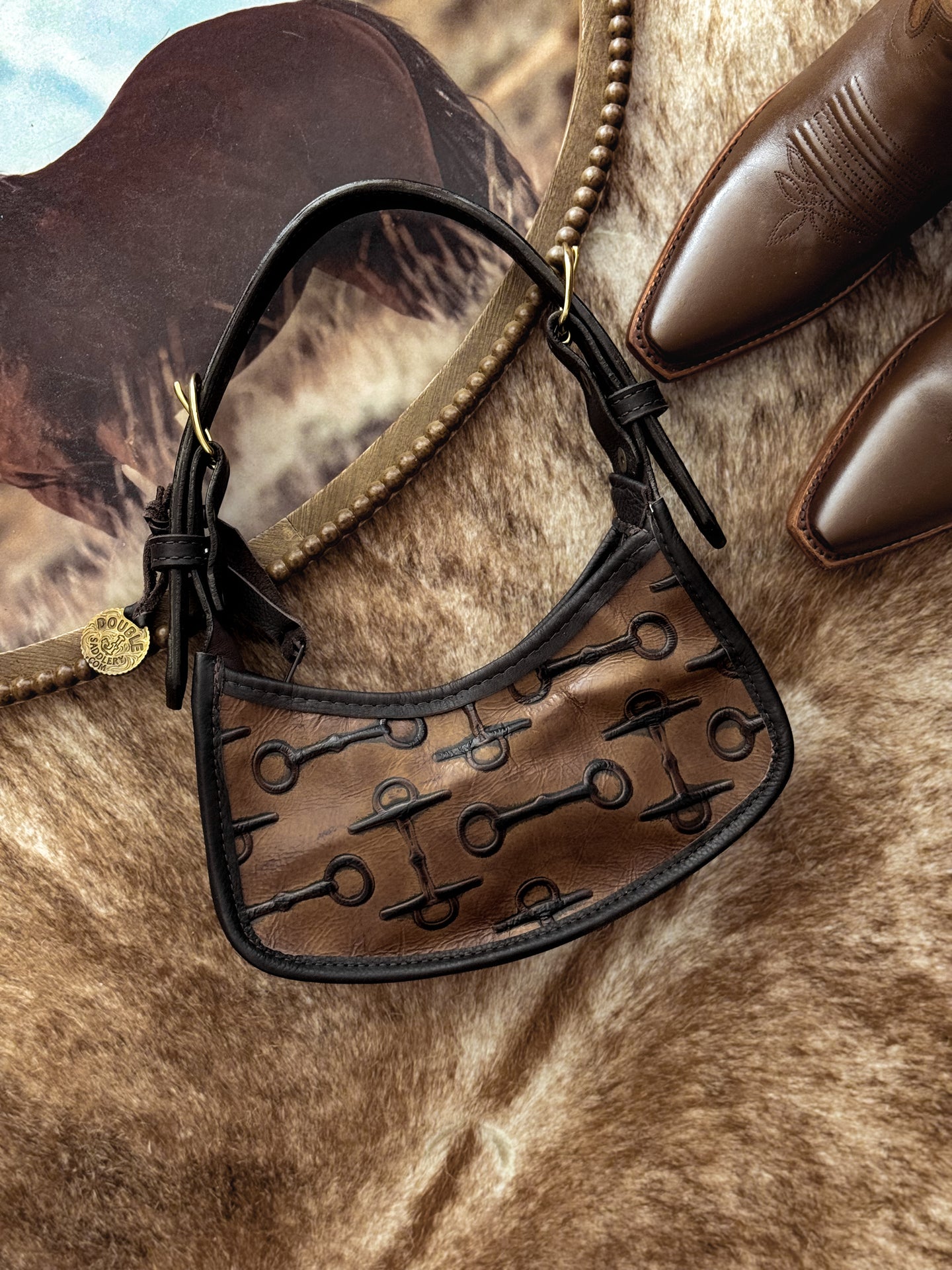 brown western leather handbag with horse bit embossing