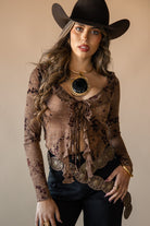 Thunderbird pendant chain necklace displayed on wooden slab with serape fabric underneath - The Wild J