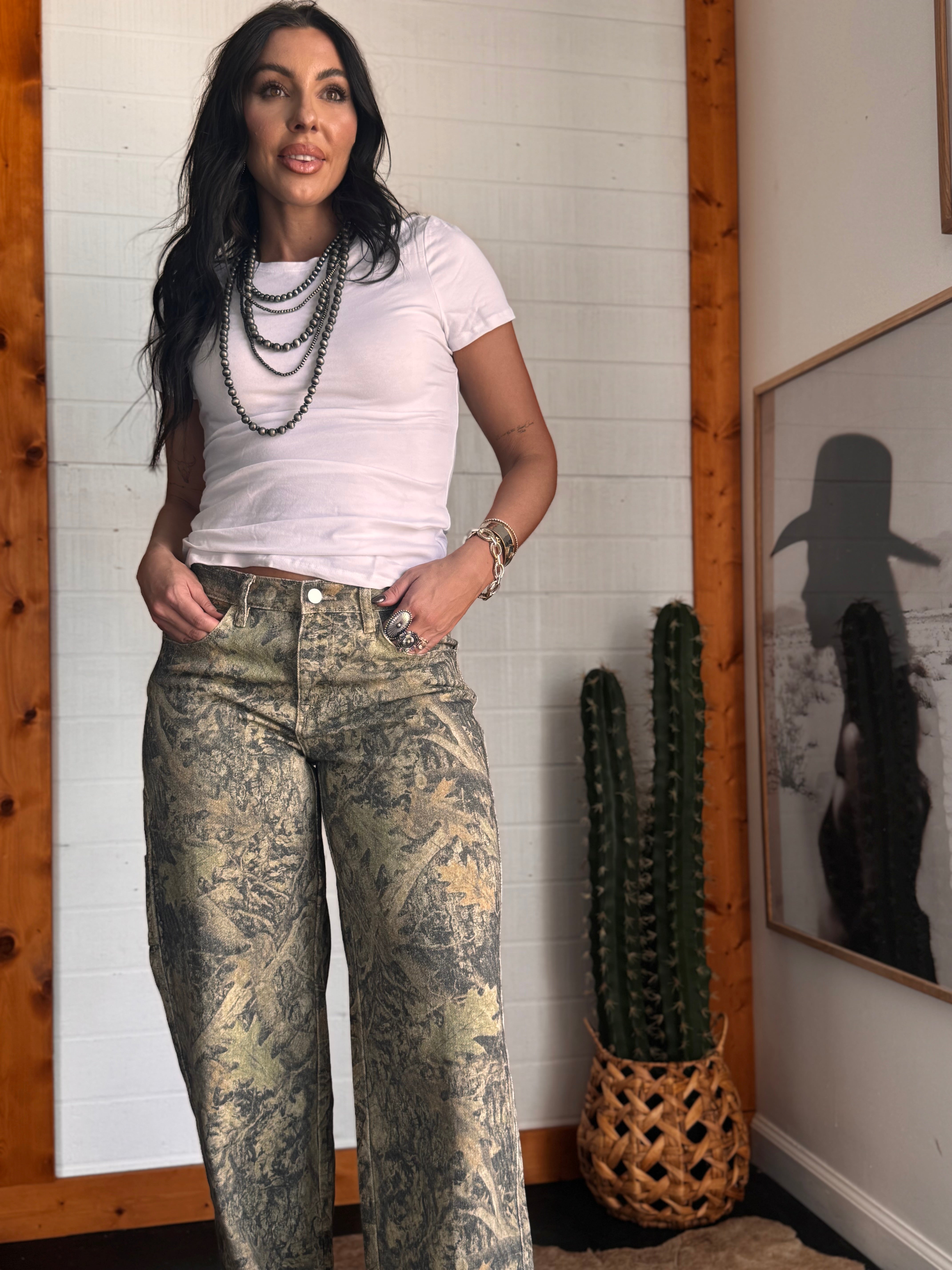 Thunderbird pendant chain necklace displayed on wooden slab with serape fabric underneath - The Wild J