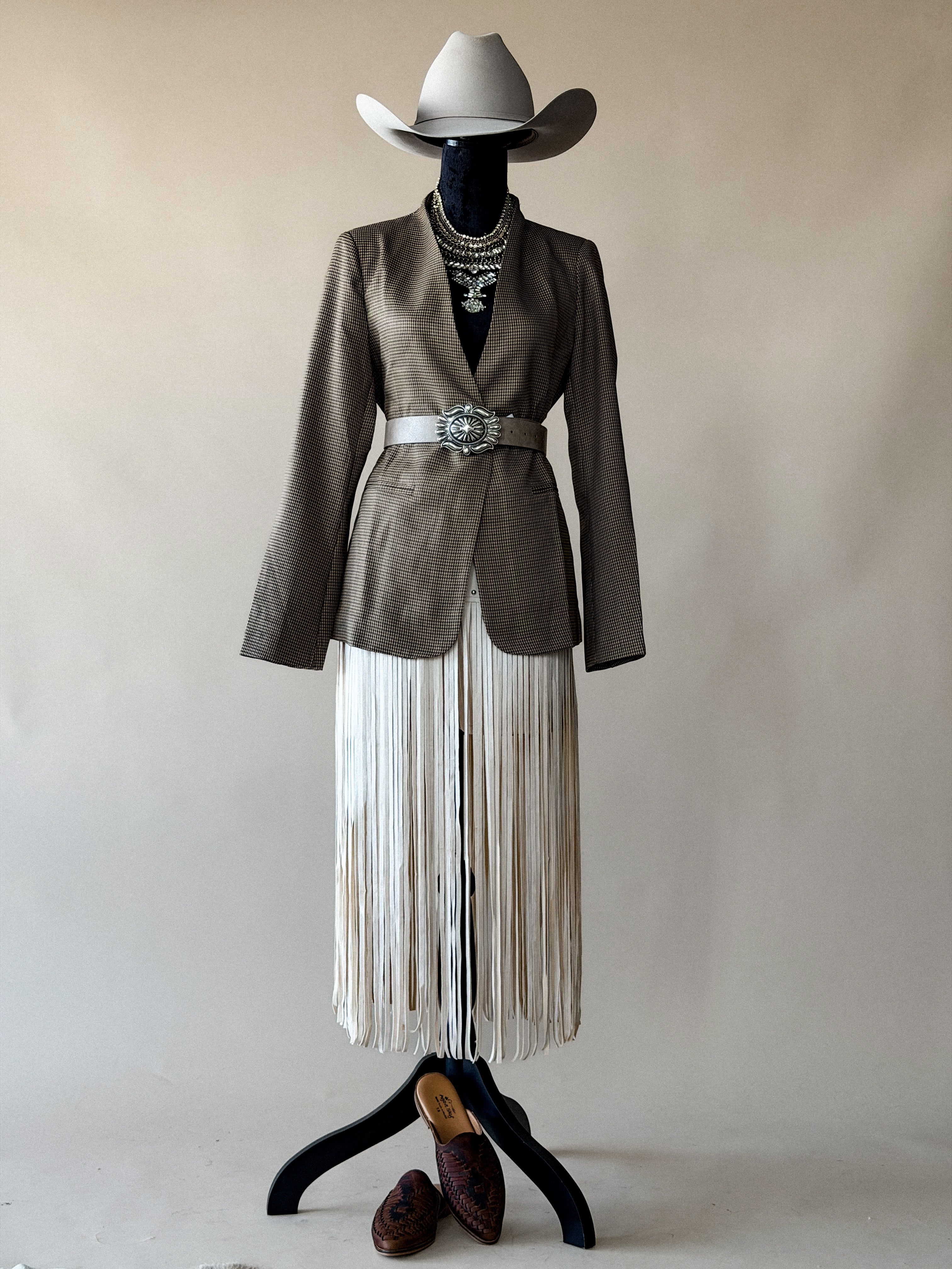 Thunderbird pendant chain necklace displayed on wooden slab with serape fabric underneath - The Wild J