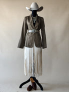 Thunderbird pendant chain necklace displayed on wooden slab with serape fabric underneath - The Wild J