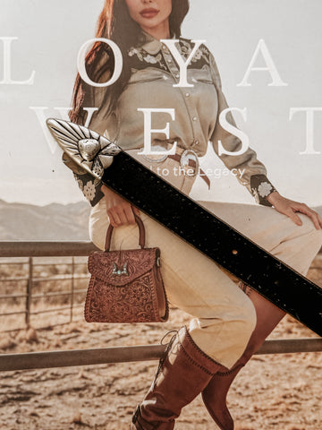 Genuine leather belt with stitched edges, featuring a matte silver-tone engraved heart buckle set including buckle, keeper, and tip.  engraved details throughout.