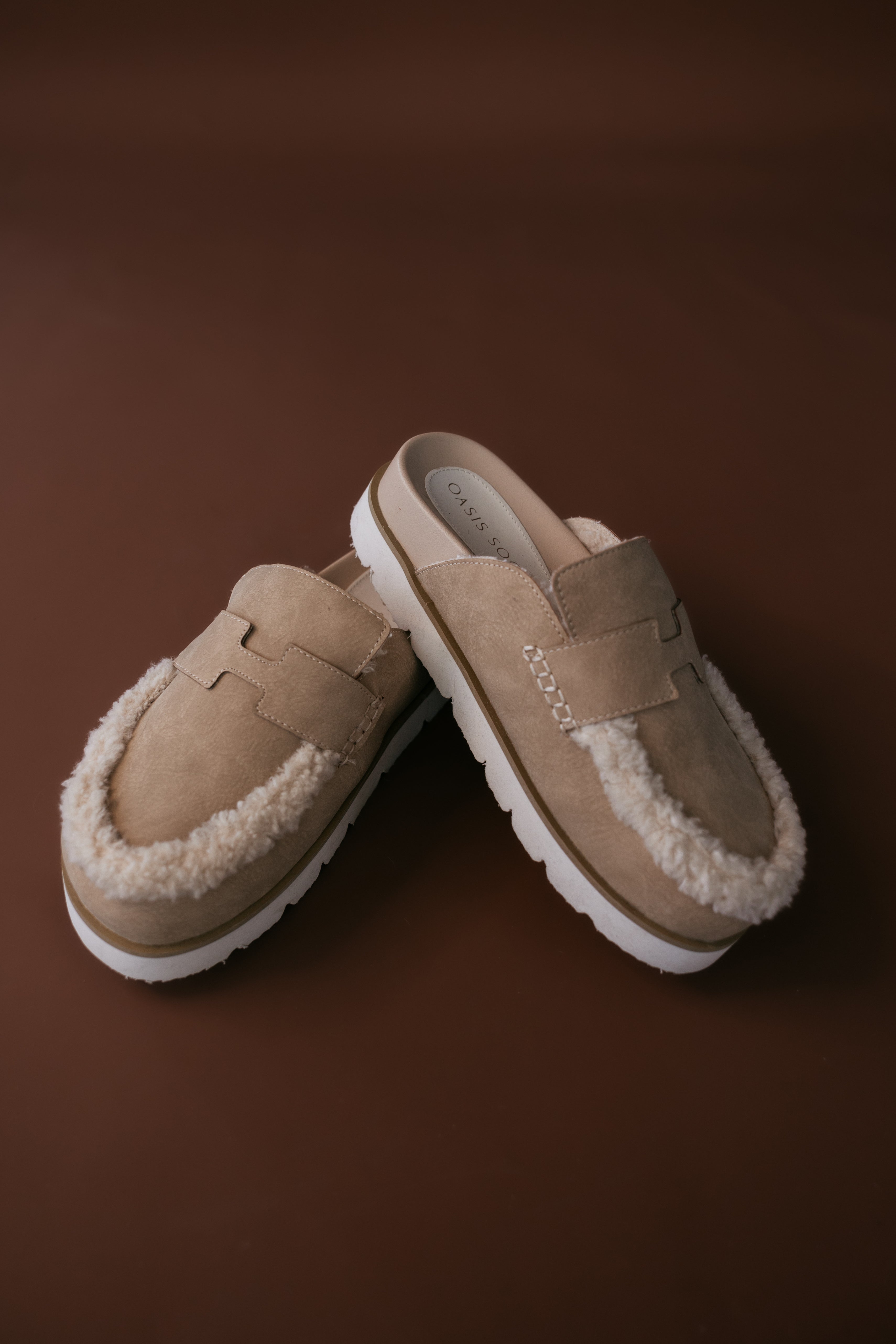 Thunderbird pendant chain necklace displayed on wooden slab with serape fabric underneath - The Wild J