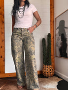 Thunderbird pendant chain necklace displayed on wooden slab with serape fabric underneath - The Wild J