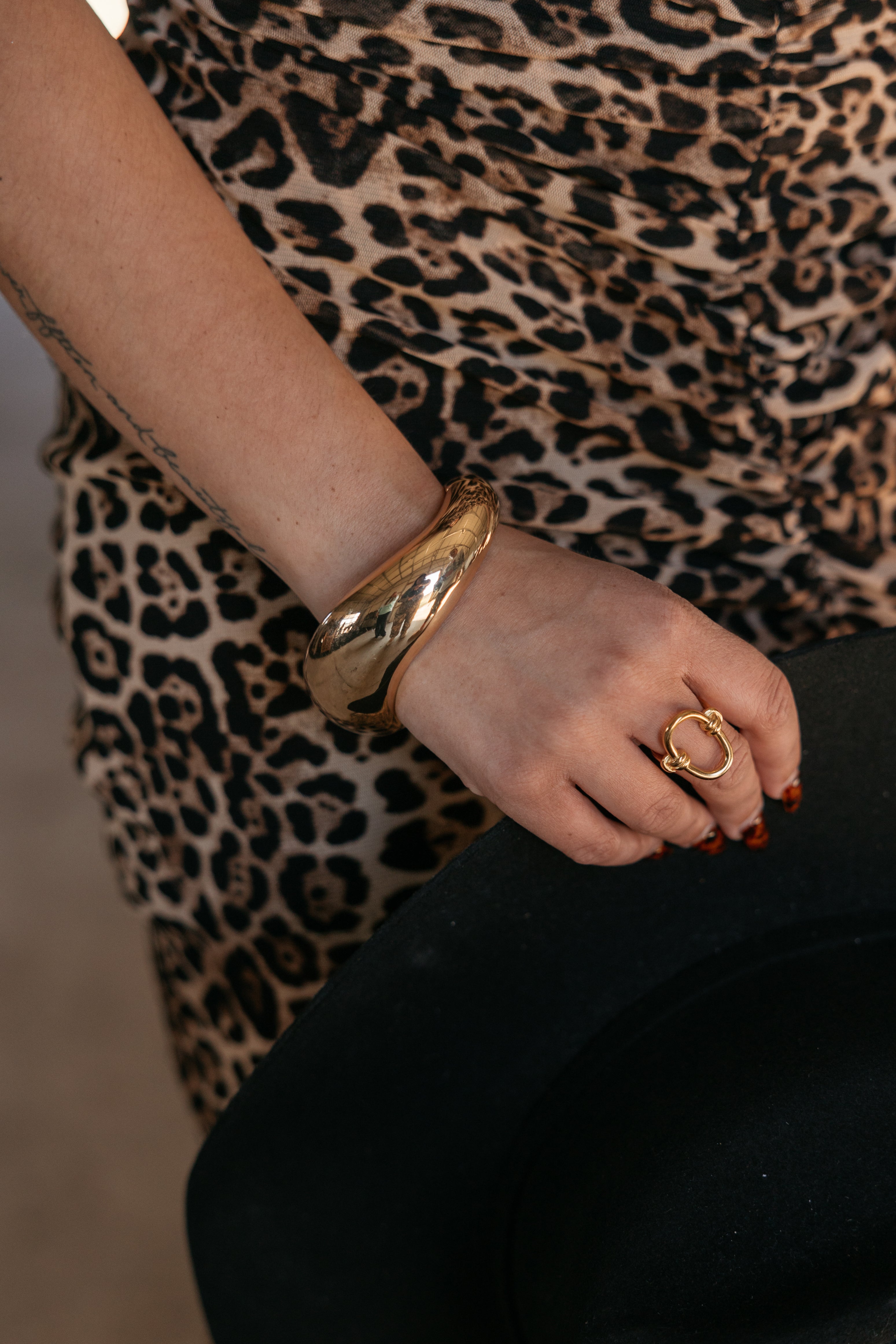 Thunderbird pendant chain necklace displayed on wooden slab with serape fabric underneath - The Wild J