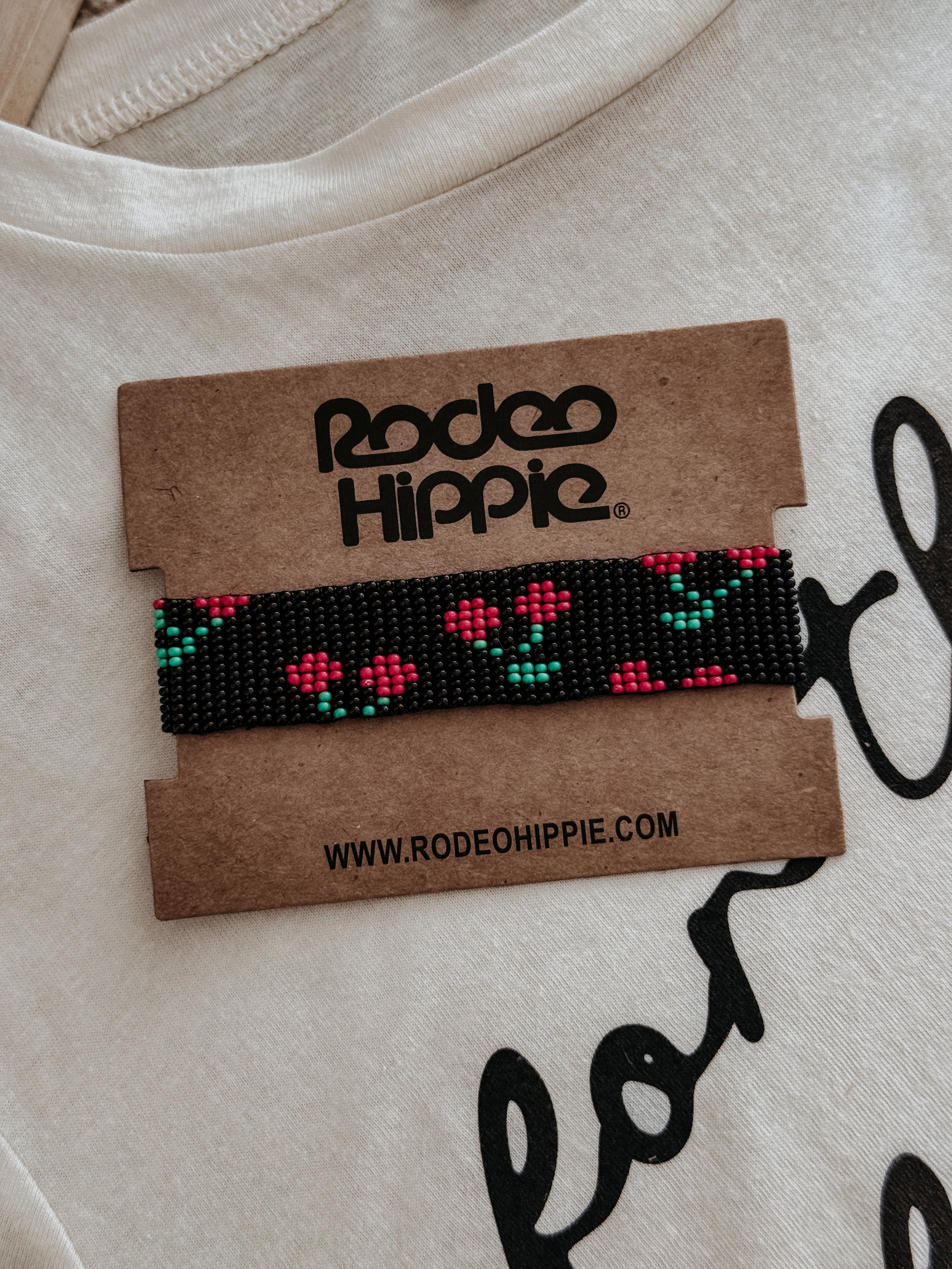 Thunderbird pendant chain necklace displayed on wooden slab with serape fabric underneath - The Wild J