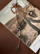 Thunderbird pendant chain necklace displayed on wooden slab with serape fabric underneath - The Wild J