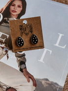 Thunderbird pendant chain necklace displayed on wooden slab with serape fabric underneath - The Wild J