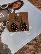 Thunderbird pendant chain necklace displayed on wooden slab with serape fabric underneath - The Wild J